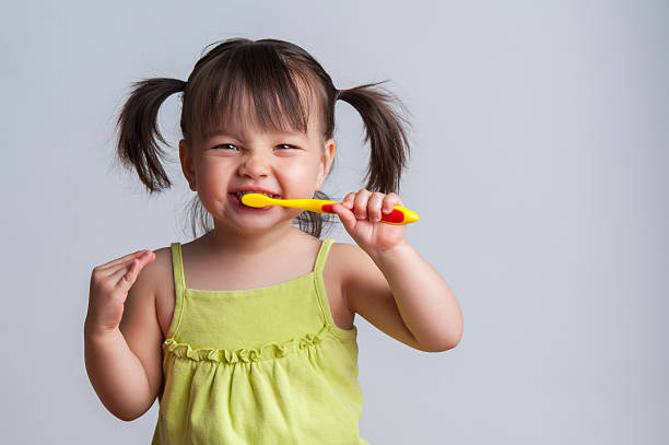 Young child brushing her teeth